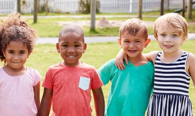 Young children outside holding hands